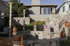 Cascading stone terraces to the wooden deck