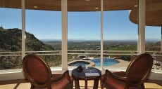 Living room overlooking pool, mountains, & city