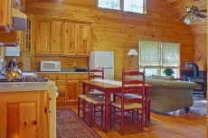 The great room has high ceilings and windows with custom shades.