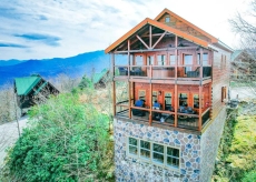 Enjoy spectacular mountain views from two large decks, firepit, comfy seating, hot tub and edison lights at night.
