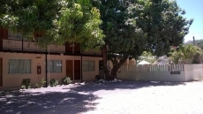 FRONT VIEW WITH SIDE VIEW OF OFFICE & POOL BEHIND FENCE  