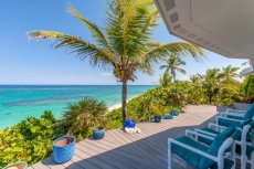 The coral reef out front and colorful fish are a short swim from the pink sandy beach.