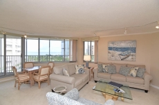 new living room furniture including sofa, loveseat, swivel chair, 4-chair game table, new art work, wet bar with under counter refrigerator over looking Gulf of Mexico