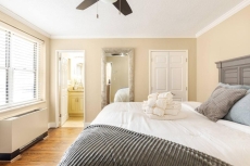 Cozy guest room w/ soft bedding & natural light for a restful stay.