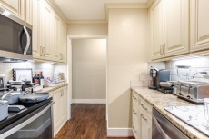 Kitchen w/ generous cabinetry & stainless appliances for home-style cooking.