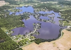 Lake Diane Luxury Estate on 2 acres with Indoor Pool, large family friendly, beautiful sand beach on 300ft shore, Large Pavilion, Firepit, 2 docks, kayaks, Paddle boat, Pontoon, Jetskies.   