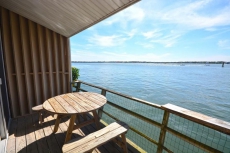 Upscale, relaxing 1 bedroom bayfront condo with free WiFi, a smart TV, and a pier directly over the bay located downtown and just a few blocks from the beach!