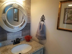 1/2 bath with custom cabinetry and granite.