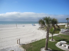View of the quiet beach with soft white pristine sand.