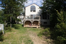 Back of house(firewood under deck).